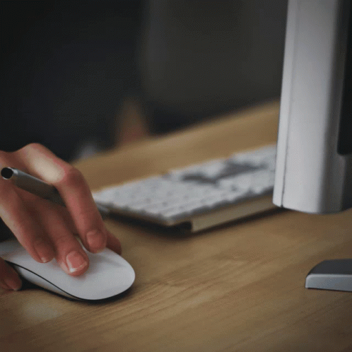 A Person Is Using A Mouse And A Pen GIF
