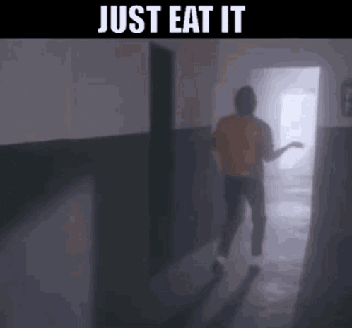 A Person Is Walking Down A Hallway With The Words `` Just Eat It '' Written On The Bottom . GIF