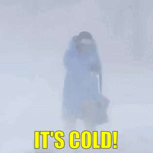 A Person Is Walking In The Snow With The Words It 'S Cold GIF