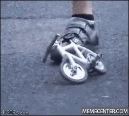 A Person Is Wearing A Pair Of Shoes That Look Like A Small Bicycle . GIF