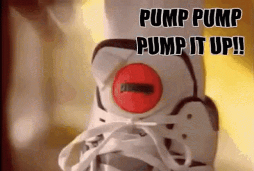 A Person Is Wearing A Pair Of White And Black Sneakers With A Red Pump On The Side Of The Shoe . GIF