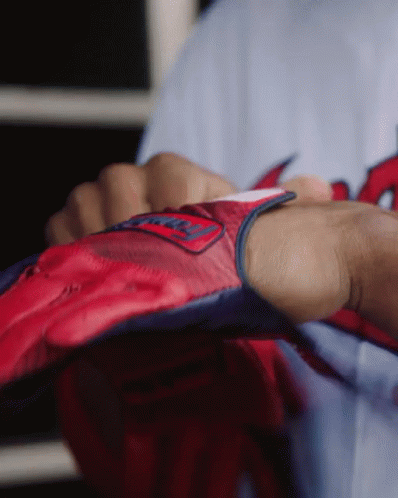 a person is wearing a red and blue glove with the word washington on it