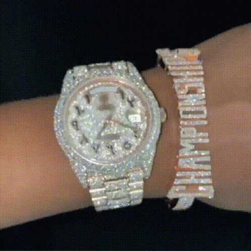A Person Is Wearing A Watch And A Bracelet That Says Champions GIF