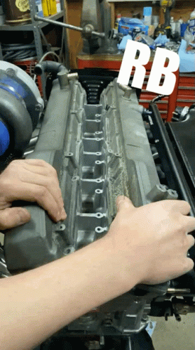 A Person Is Working On A Car Engine With The Letters Rb Visible GIF