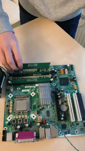 A Person Is Working On A Motherboard That Says Hp GIF