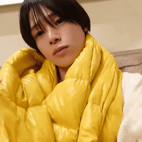 A Person Is Wrapped In A Yellow Scarf GIF