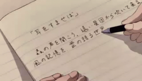 A Person Is Writing In A Notebook With Chinese Characters GIF