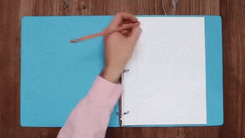 A Person Is Writing On A Piece Of Paper In A Binder . GIF