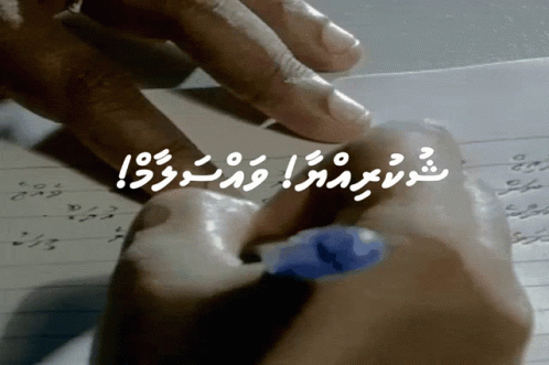 A Person Is Writing On A Piece Of Paper With A Blue Marker GIF