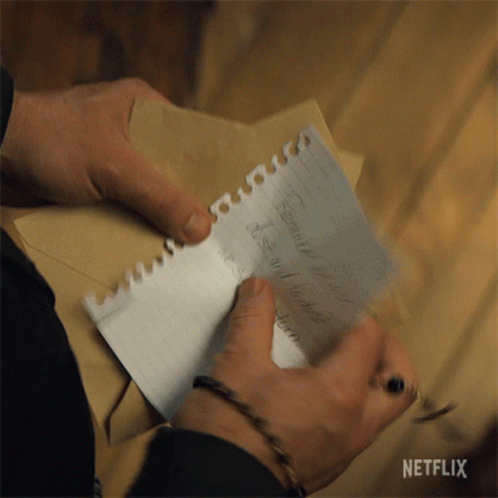 A Person Is Writing On A Piece Of Paper With A Netflix Logo In The Corner GIF