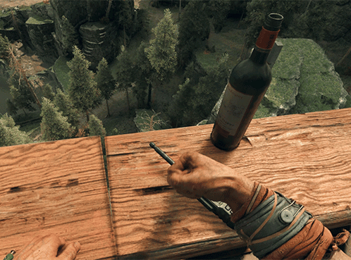 A Person Is Writing On A Piece Of Wood Next To A Bottle Of Wine That Says Chateau GIF