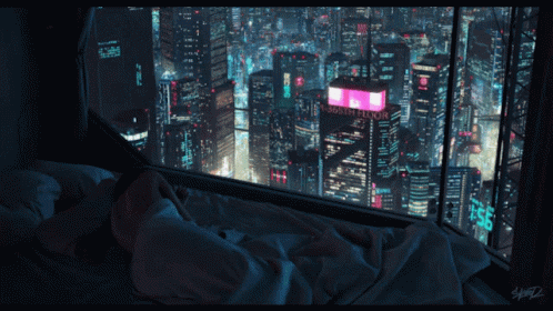 A Person Laying In A Bed Looking Out A Window At A City At Night With A Sign That Says " Floor " GIF