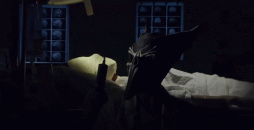 A Person Laying In A Hospital Bed With A Mask On GIF
