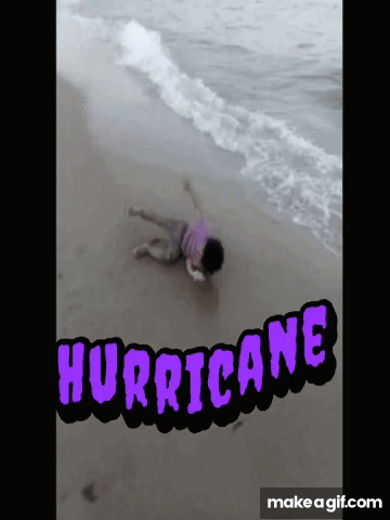A Person Laying On A Beach With The Word Hurricane Written On It GIF