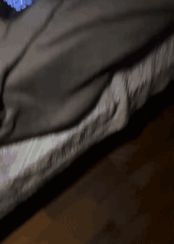 A Person Laying On A Bed With A Blanket On GIF
