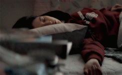 A Person Laying On A Bed With A Sweatshirt On That Says Harvard GIF