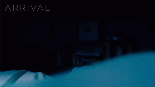 A Person Laying On A Bed With The Word Arrival Behind Them GIF