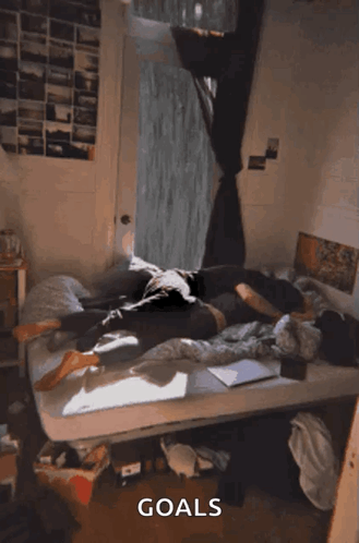 A Person Laying On A Bed With The Word Goals Written On The Bottom GIF