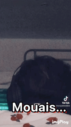 A Person Laying On A Bed With The Words Mouais Written On The Screen GIF