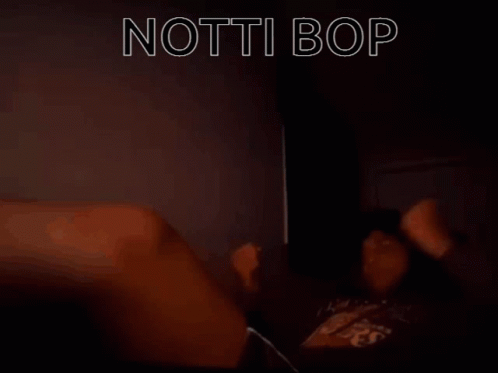 A Person Laying On A Bed With The Words " Notti Bop " In White Letters GIF