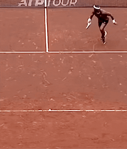 a person laying on a tennis court with the word atp on it
