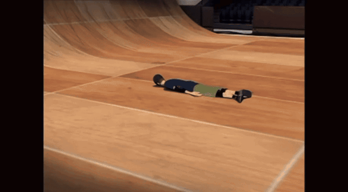 A Person Laying On Their Back On A Skateboard GIF