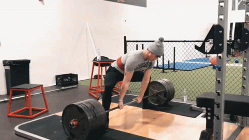 A Person Lifting A Barbell In A Gym With A Chicago Shirt On GIF