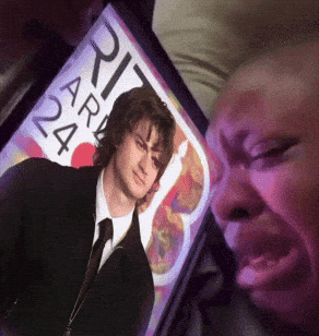 A Person Looking At A Picture Of A Man With The Number 24 On The Screen GIF