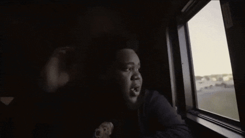 A Person Looking Out Of A Window With A Hole In It GIF