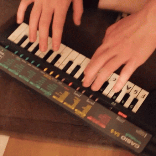 A Person Playing A Casio Keyboard With Their Fingers On The Keys GIF