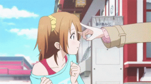 A Person Pointing At A Girl 'S Face In Front Of A Building With Chinese Writing GIF