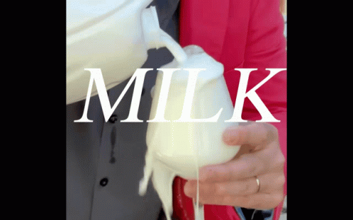 A Person Pouring Milk Into A Glass With The Word Milk Written On It GIF
