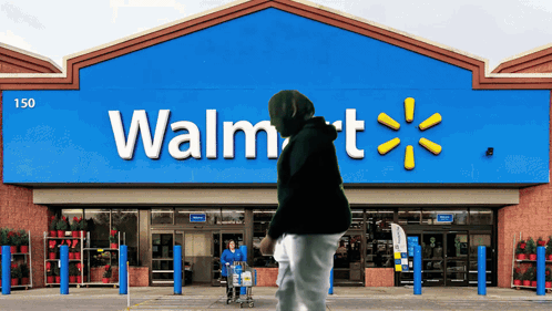 A Person Pushing A Shopping Cart In Front Of A Walmart GIF