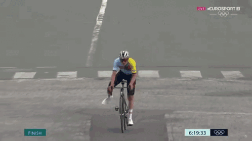 A Person Riding A Bike Across A Finish Line With Omega Written On The Bottom GIF