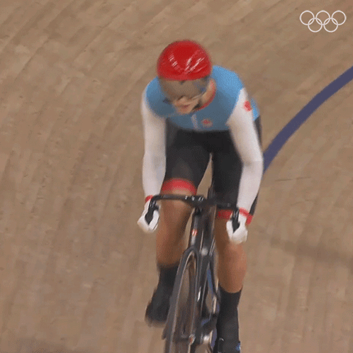 A Person Riding A Bike On A Track With The Number 1 On Their Shirt GIF