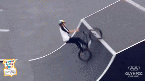 A Person Riding A Bike On A Track With The Olympic Channel Logo GIF
