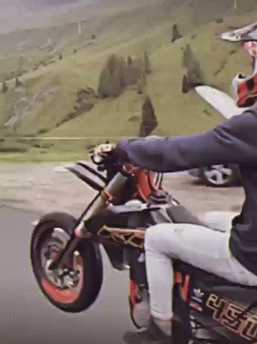 A Person Riding A Dirt Bike With A Sticker On The Back That Says ' R.e.t.o. ' GIF