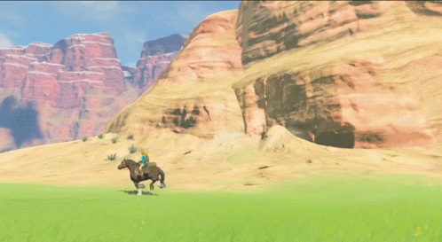 A Person Riding A Horse In A Desert With Mountains In The Background GIF