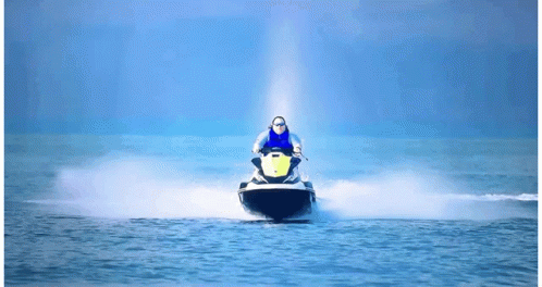 A Person Riding A Jet Ski With A Yellow Sticker On The Front GIF
