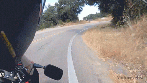 A Person Riding A Motorcycle On A Road With The Word Motorcyclist On The Bottom Right GIF