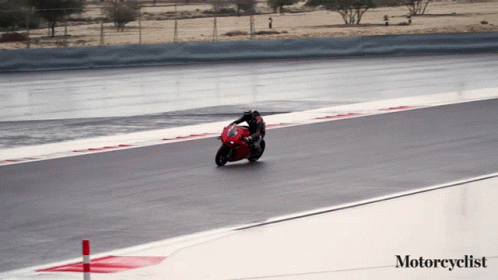 A Person Riding A Red Motorcycle On A Track With The Words Motorcyclist Below Them GIF
