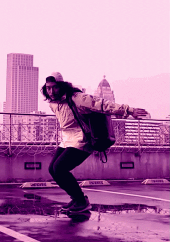 A Person Riding A Skateboard In A Parking Lot With A Sign That Says ' Taxi ' On It GIF