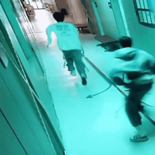 A Person Running Down A Hallway With A Shirt That Says " Never Give Up " On It GIF