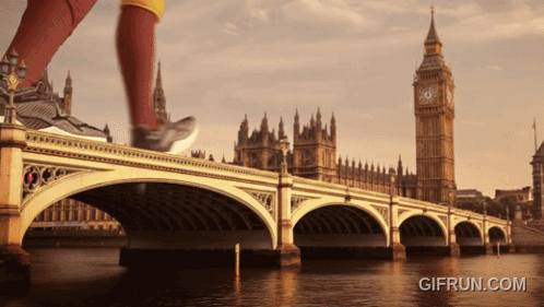 a person running on a bridge with a big ben in the background