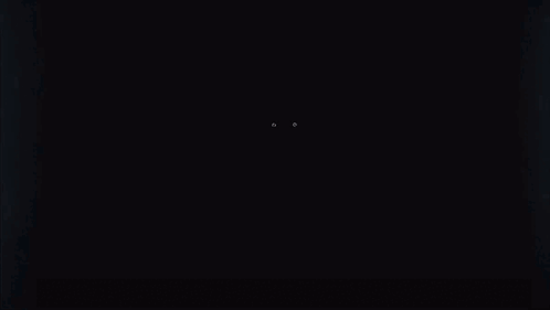 A Person 'S Eyes Are Glowing In The Dark In A Dark Room . GIF