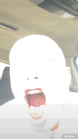 A Person 'S Face Is Visible In A Car With A Tiktok Sticker On The Bottom GIF