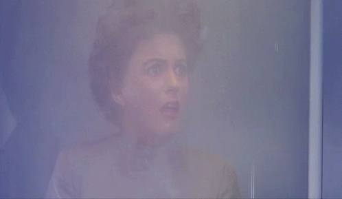 A Person 'S Face Is Visible In A Foggy Room In A Blurry Photo GIF