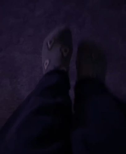 A Person 'S Feet Are Shown In A Dark Room With A Purple Carpet GIF