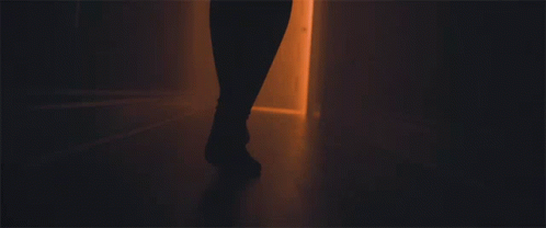 A Person 'S Feet Are Shown Walking Through A Doorway GIF
