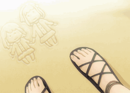 A Person 'S Feet In Sandals On The Beach GIF